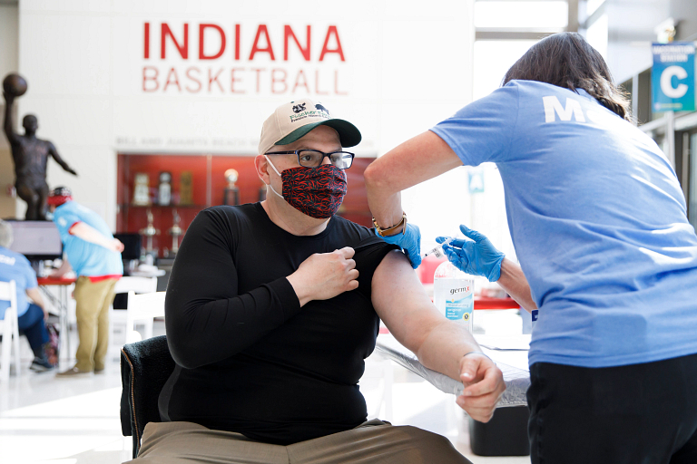 An IU staff member gets the COVID-19 vaccine at Assembly Hall in Bloomington