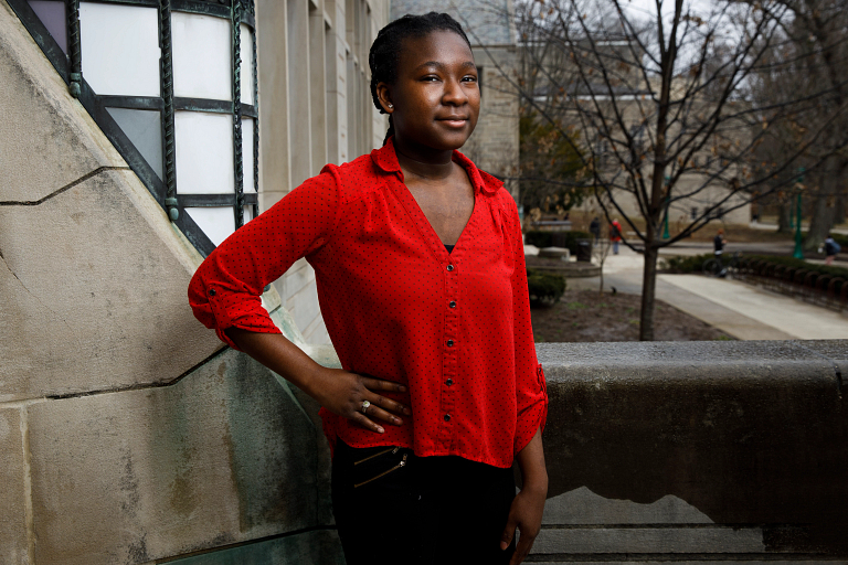 Wisdom Ibikunle poses in front of Woodburn Hall