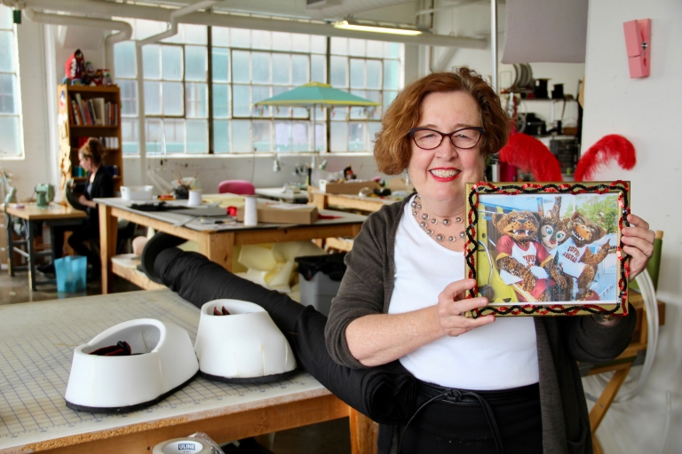 Jennifer Smith stands in her mascot-creating Indianapolis studio with a picture of Jawz and Jazzy