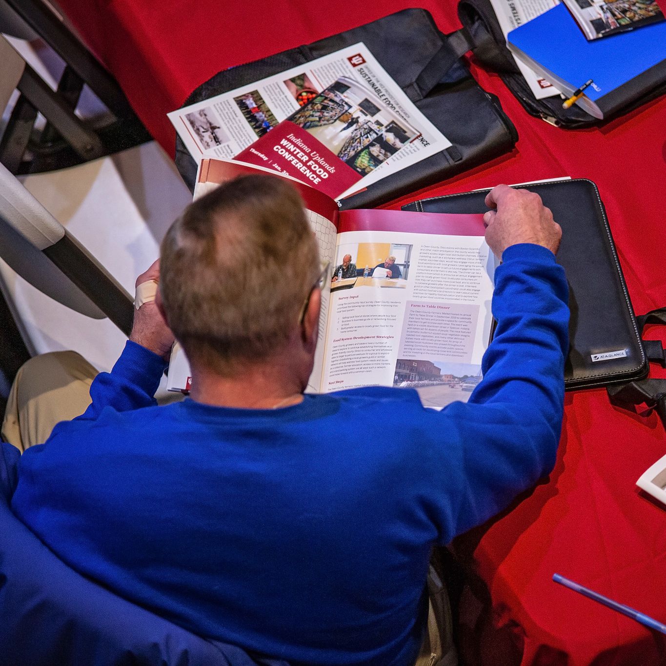 A man looks at handouts during the conference