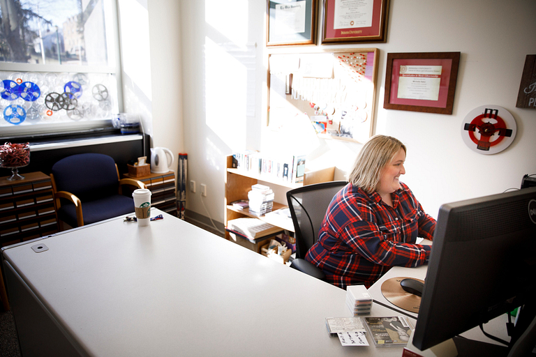 Michelle Hahn sits at her desk. 