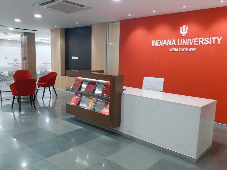 Lobby area with chairs and a desk in the IU India Gateway office