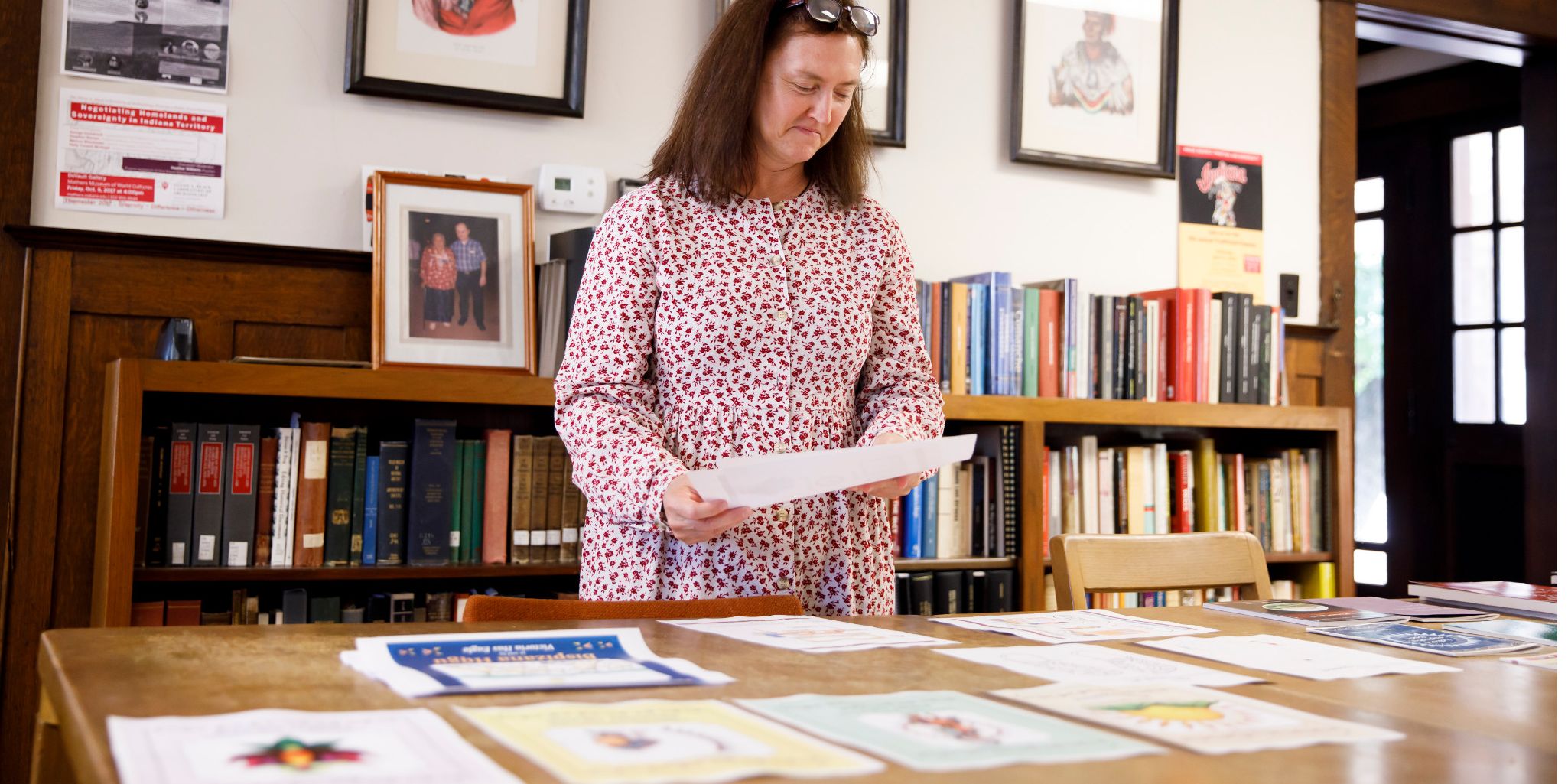 Cynthia Ramlo holds print-out drafts of Nakoda textbooks 