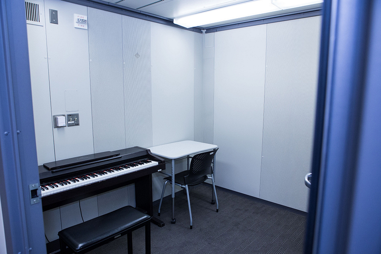 This small, multiuse room holds a piano keyboard, a table and chair.