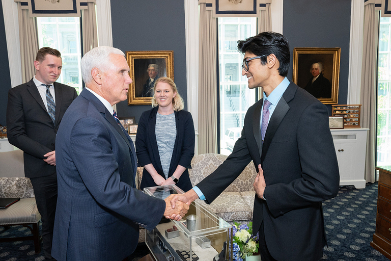 Mike Pence shakes hands with Ebin Daniel.