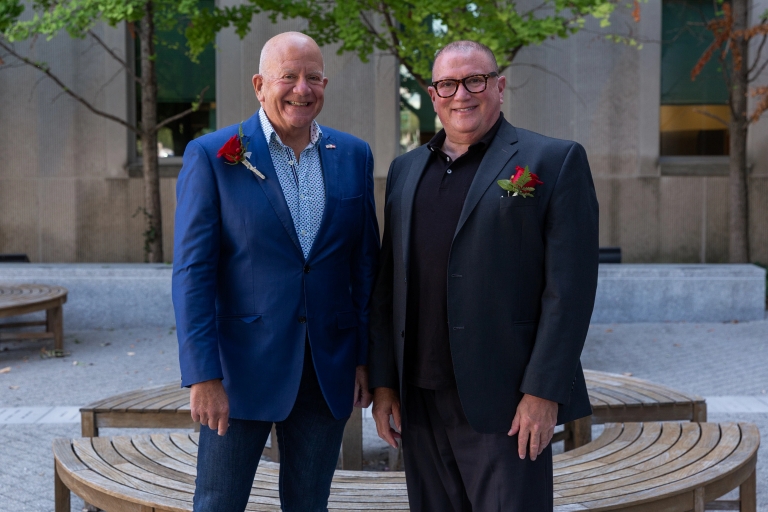 Steve Tuchman and his husband Reed Bobrick standing outside Inlow Hall