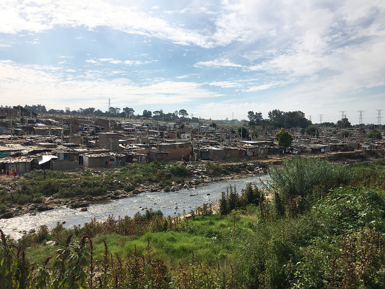 Slum of Johannesburg near a stream