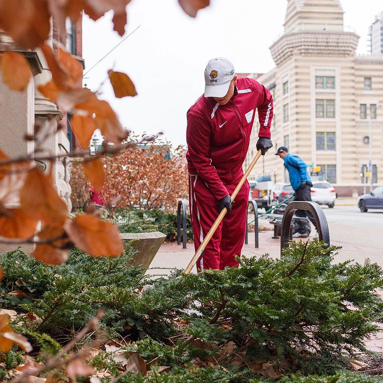 IUPUI student volunteer with a shovel