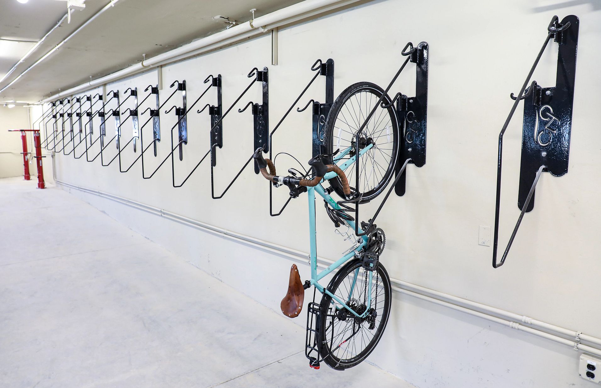 A bike hangs on a vertically mounted bike rack