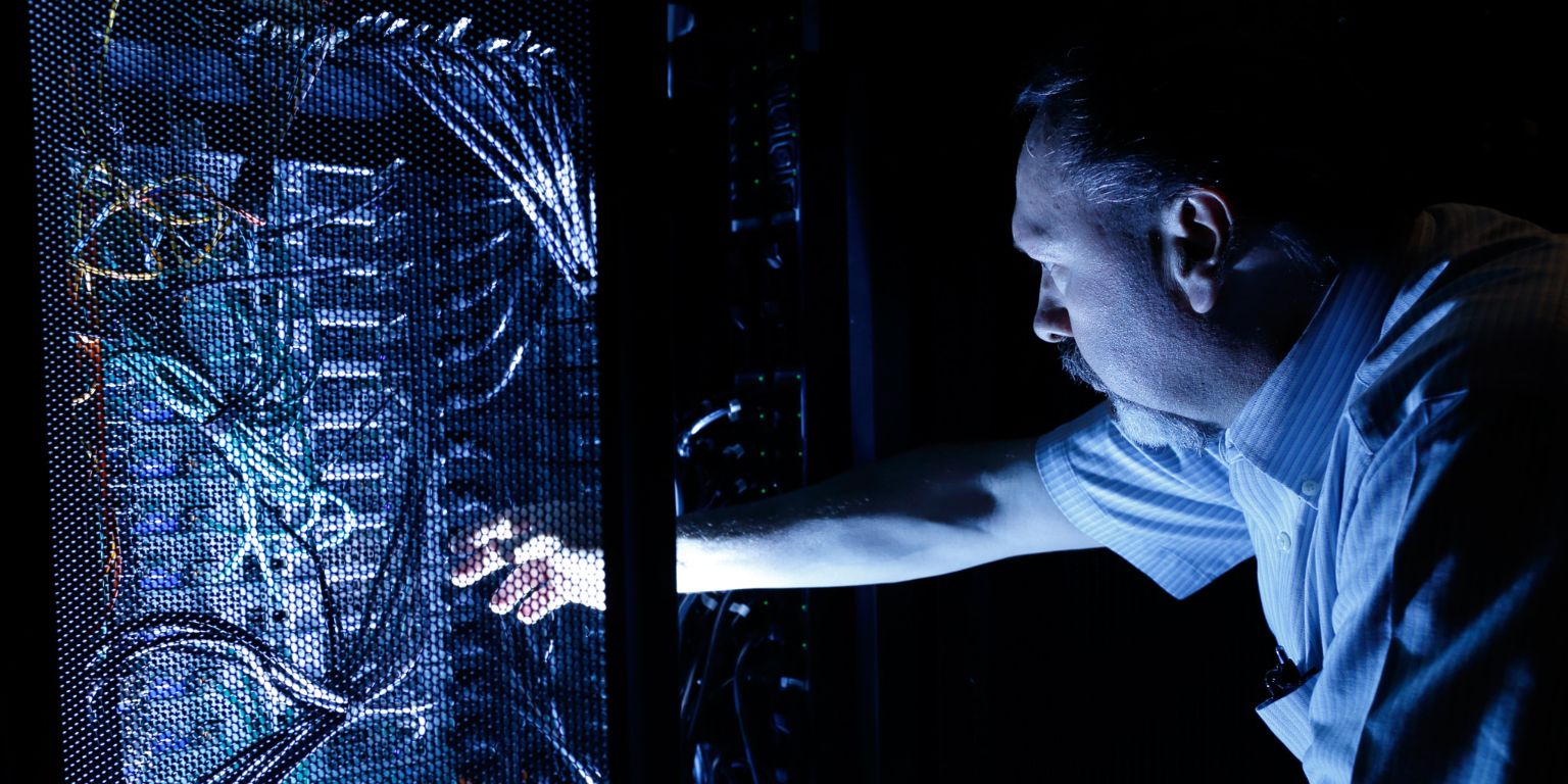 IU employee adjusts a computer at the data center.