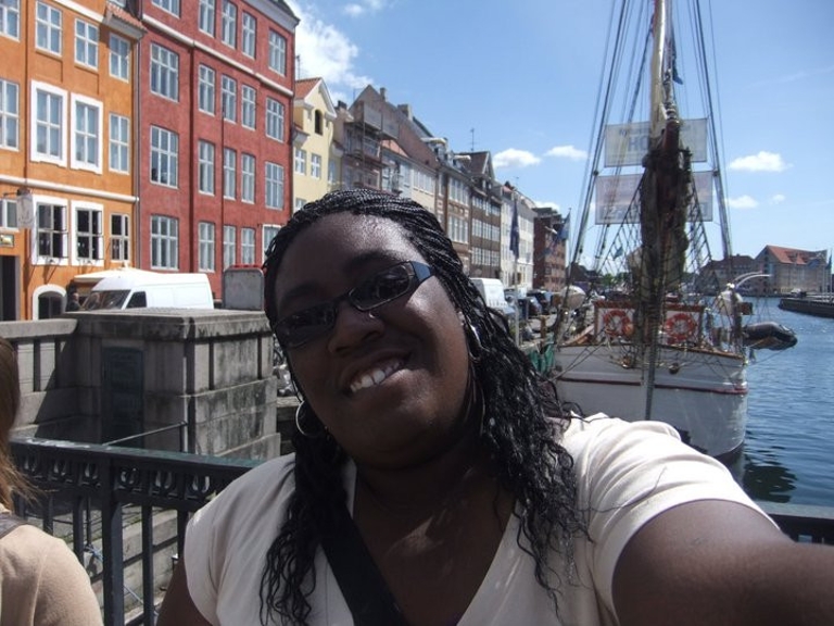 Taylor Rhodes standing along a canal in Denmark.