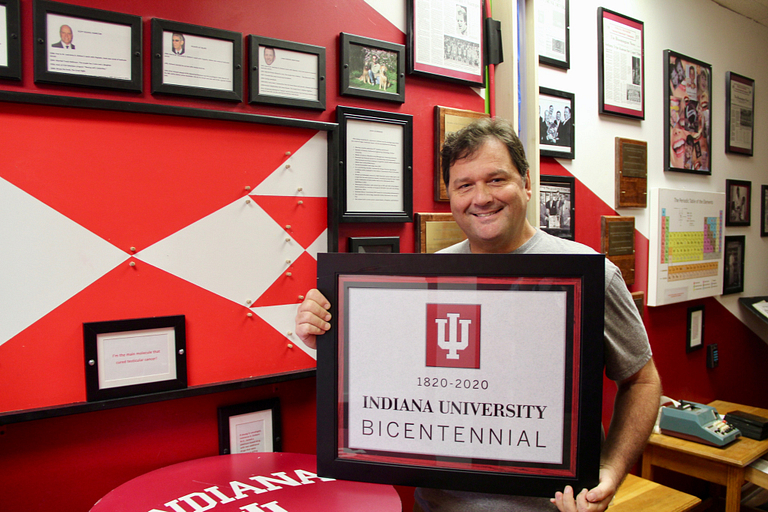 Scott Neal holds the bicentennial plaque.