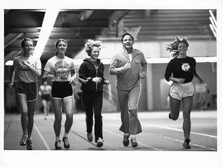 Birch Bayh running alongside four women