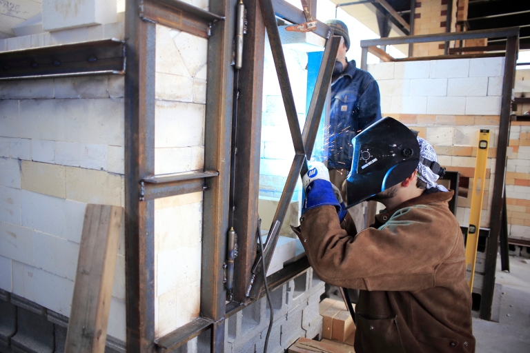 Student welds in class.