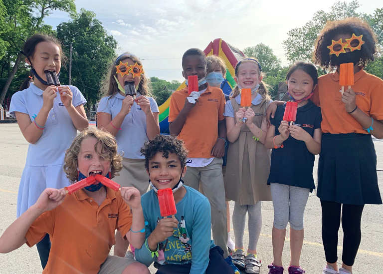 Children eating popsicles at a language camp