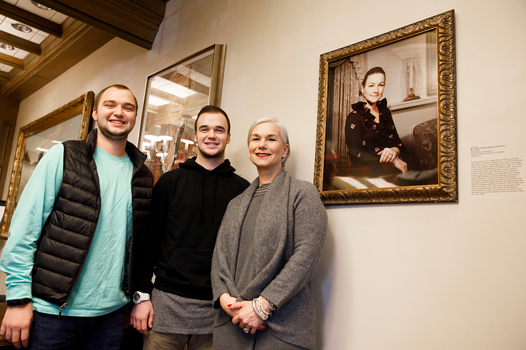Andrew Gutman, left, Phillip Gutman and Gretchen Gutman pose with a framed photo of Carolyn Gutman.