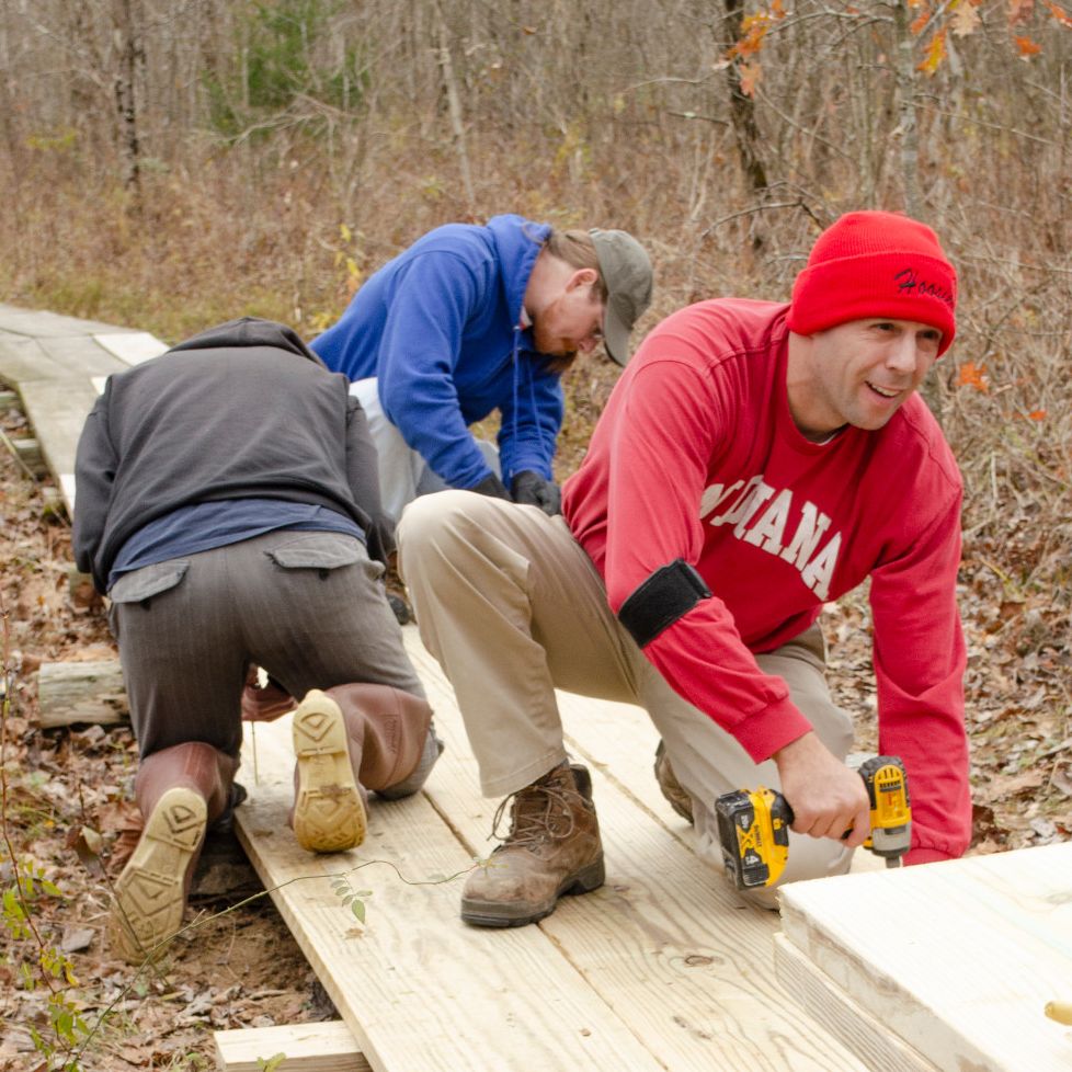 Mike Noth secures a fresh plank to the wood boardwalk at Beanblossom Bottoms.