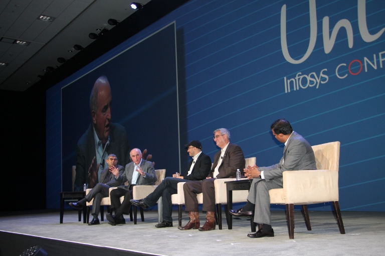 President McRobbie on stage during a panel with other speakers