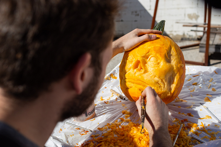 David King carves a face into a pumpkin.