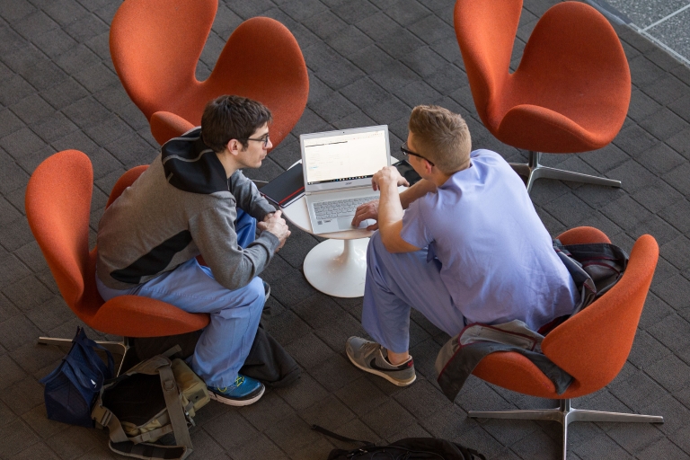 Students sitting in chairs on the IUPUI campus.