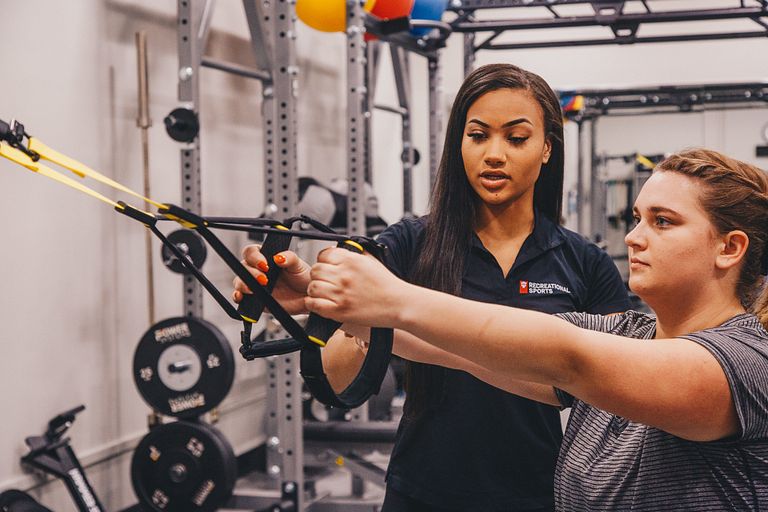 A client works with a personal trainer at the IU Student Recreational Sports Center