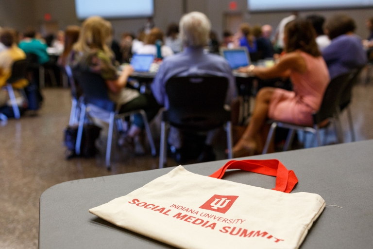 A bag that says social media summit sits on a table. 