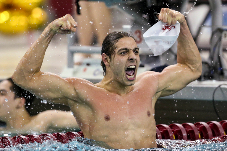 Vini Lanza flexes in the pool to celebrate after a swim