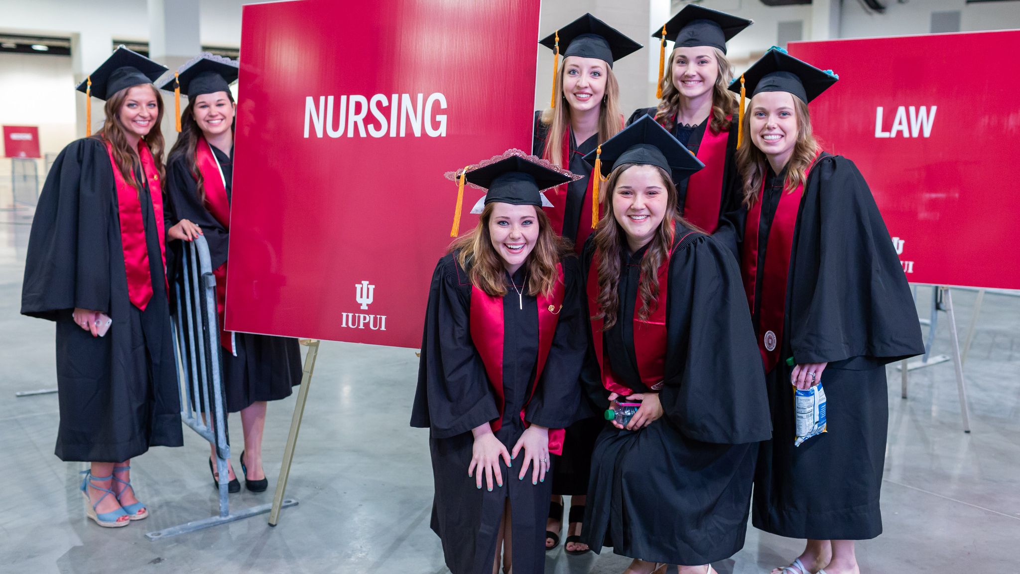 Graduates pose at the IUPUI commencement at Lucas Oil Stadium.