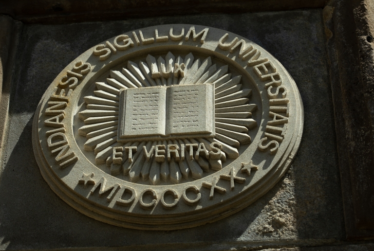 "Lux et Veritas" is displayed on the side of a building