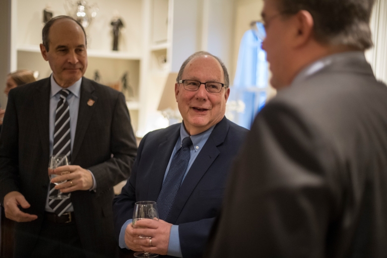 Bill Stephen, Bob Zaltsberg and Fred Cate, from left, talk at a reception