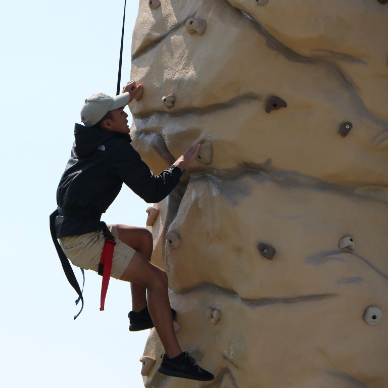 An IU East student climbs a rock wall