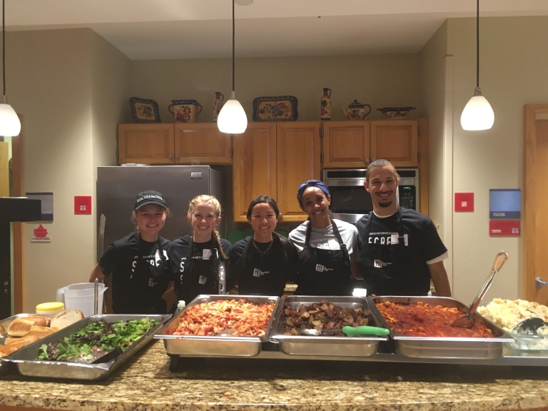IUPUI Campus Kitchen student volunteers with trays of food.