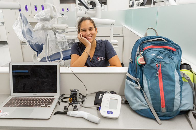 Maria Contreras sits with her dentistry equipment.