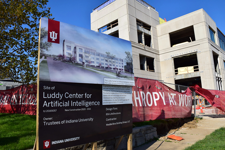 A sign with a rendering outside the Luddy Center for Artificial Intelligence under construction