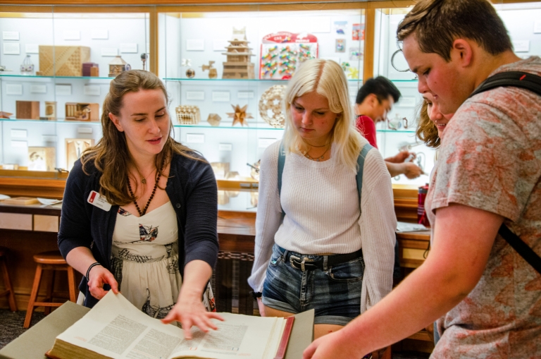 Librarian shows items from Lilly Collection