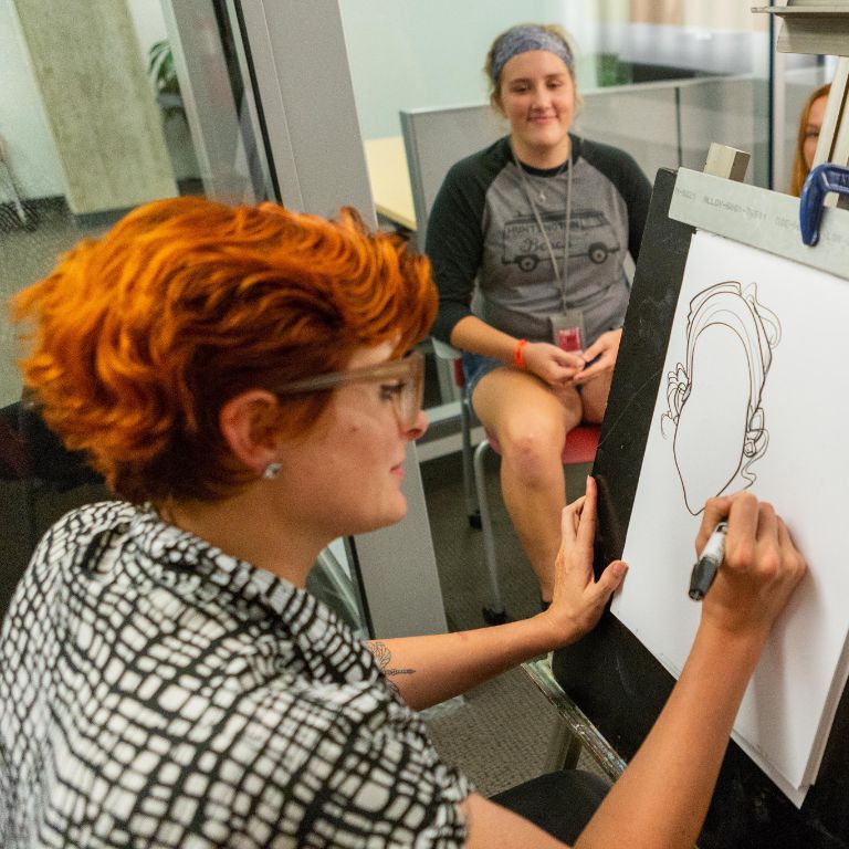 Student having her caricature drawn
