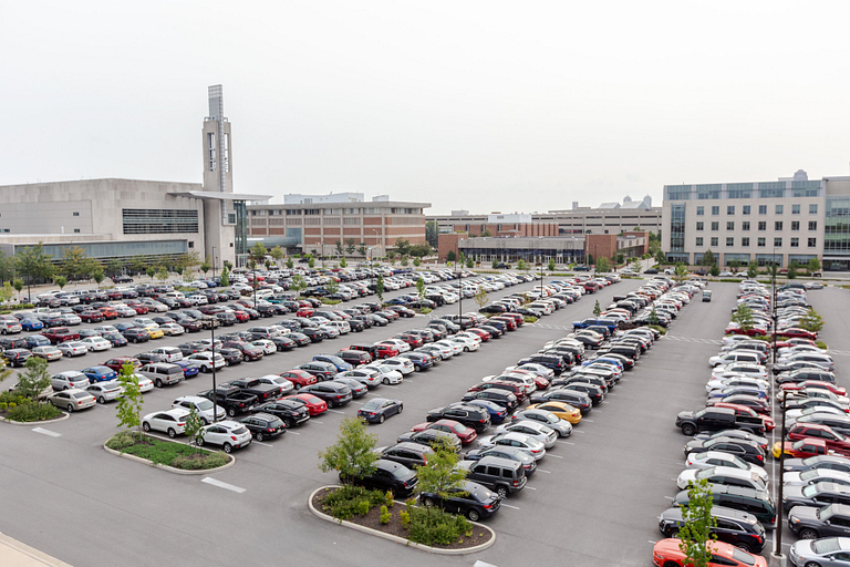 The parking lot is full of cars in a central lot near the Campus Center at IUPUI.