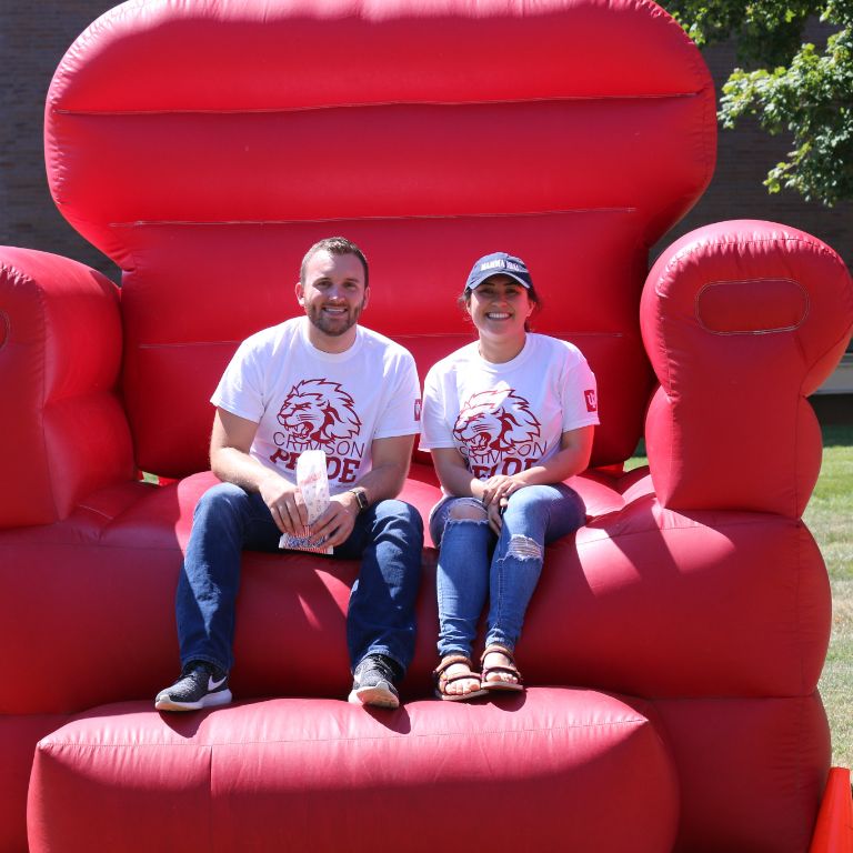 Two IUPUC students sit in a large inflatable chair