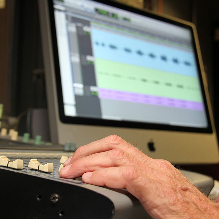 A hand on a sound mixer.