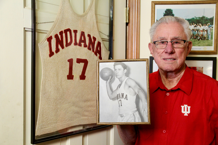 Dr. Marvin Christie holds a picture of himself.