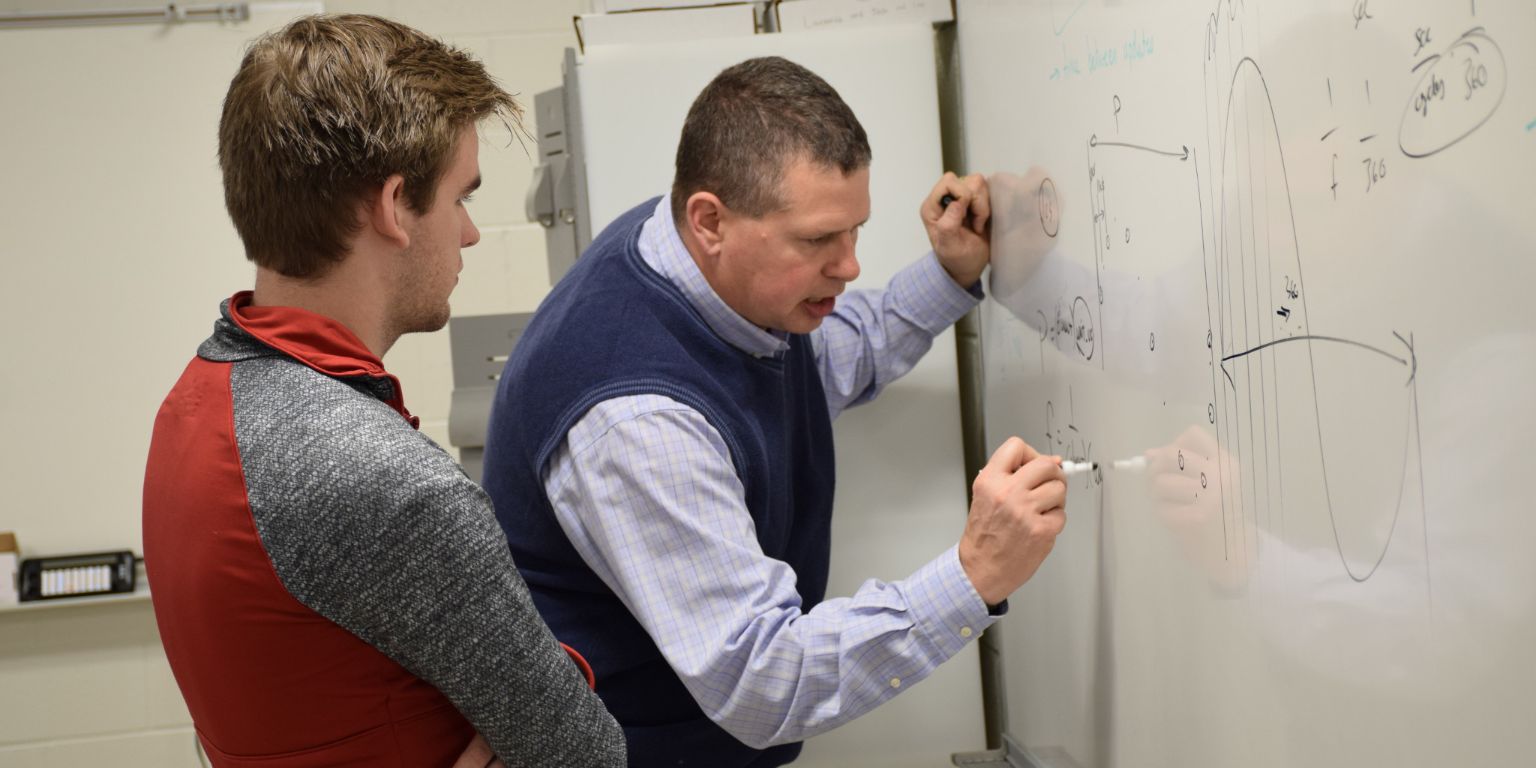Professor Bryce Himebaugh works with a student.