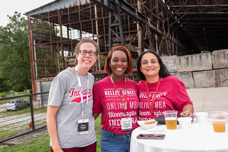 Three women pose for a photo together.