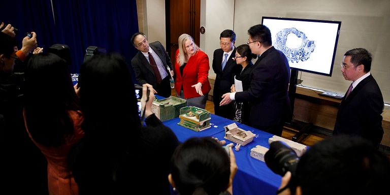 Repatriation ceremony artifacts with dignitaries and media
