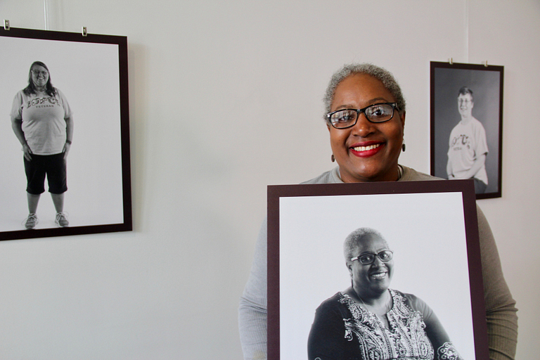 Lavonne Addison holds her picture in the cultural arts gallery.