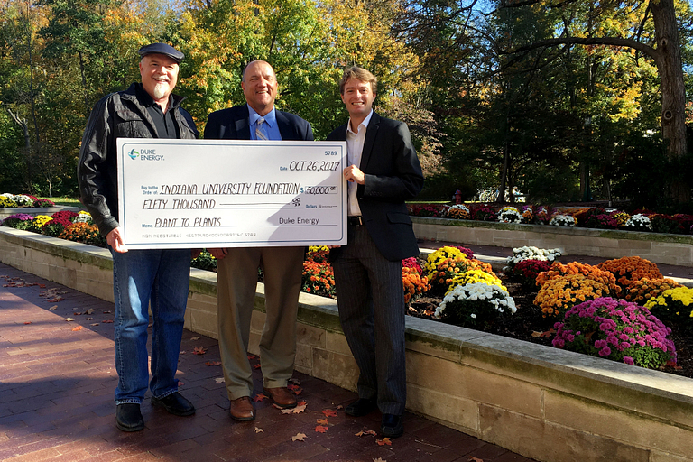 Chip, Bruce and Mark holding a giant check from Duke. 