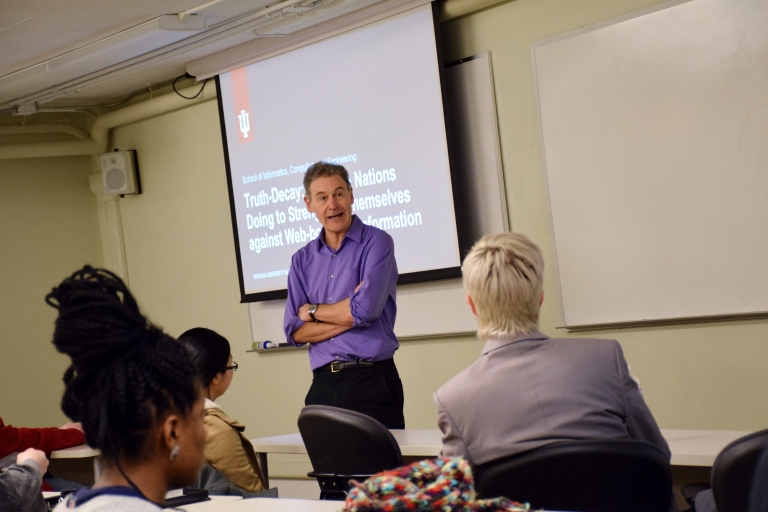 Michael Hamburger in front of a classroom