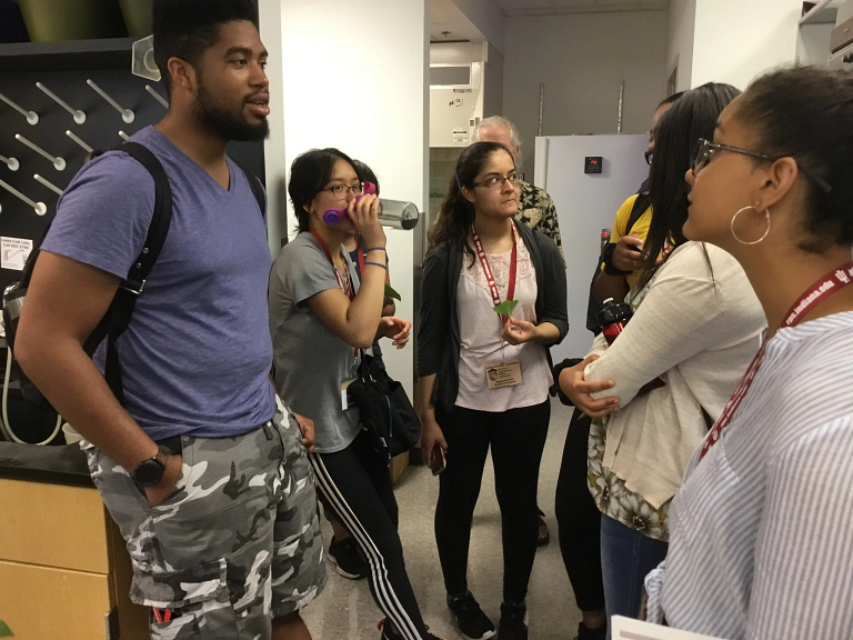 Students talk while gathered in a group