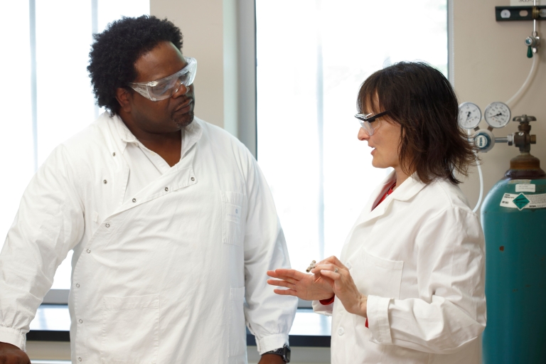 Dean Rowe-Magnus, left, and Nicola Pohl discuss their antimicrobial peptide for diabetic foot ulcers