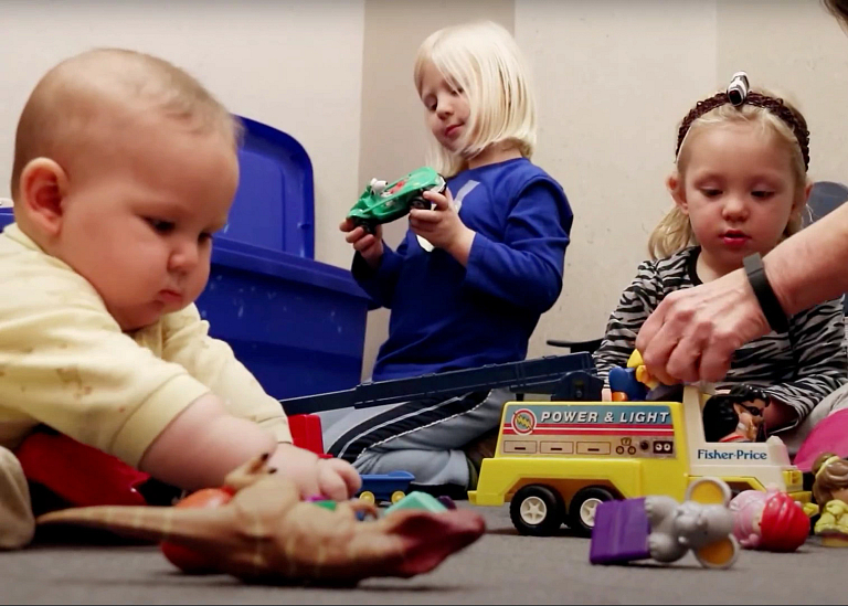 Children and an infant interact with objects in the lab