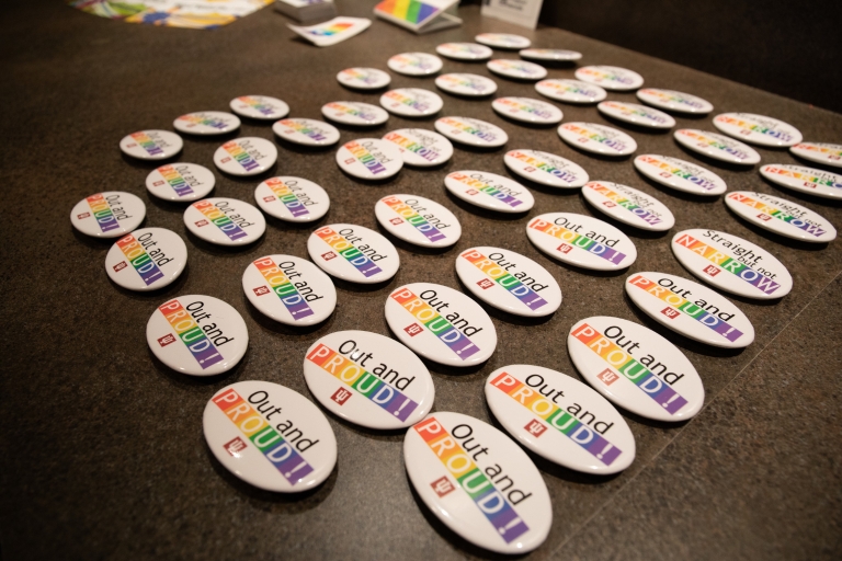 Out and proud buttons lying on a table